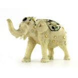 λ A Japanese ivory Shibayama model of an elephant, Meiji period, wearing a saddle strolling with