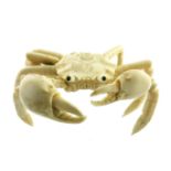 λ A Japanese ivory okimono, Meiji period, 1868-1912, carved as a crab with articulated pincers and