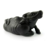 A Chinese hardwood treen netsuke, in the form of a recumbent water buffalo, signed, 8.5cm wide