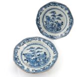 A pair of late 18th Century Chinese blue and white soup plates, painted with bamboo trees and