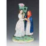 A Staffordshire figure group spill vase, circa 1880, modelled as Snow White and a witch standing bef