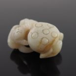A Chinese pale jade netsuke, in the form of a man with a giant gourd, brown veined inclusions, 5.5cm