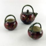 William Moorcroft, a Pomegranate on ochre three piece tea set, circa 1914,