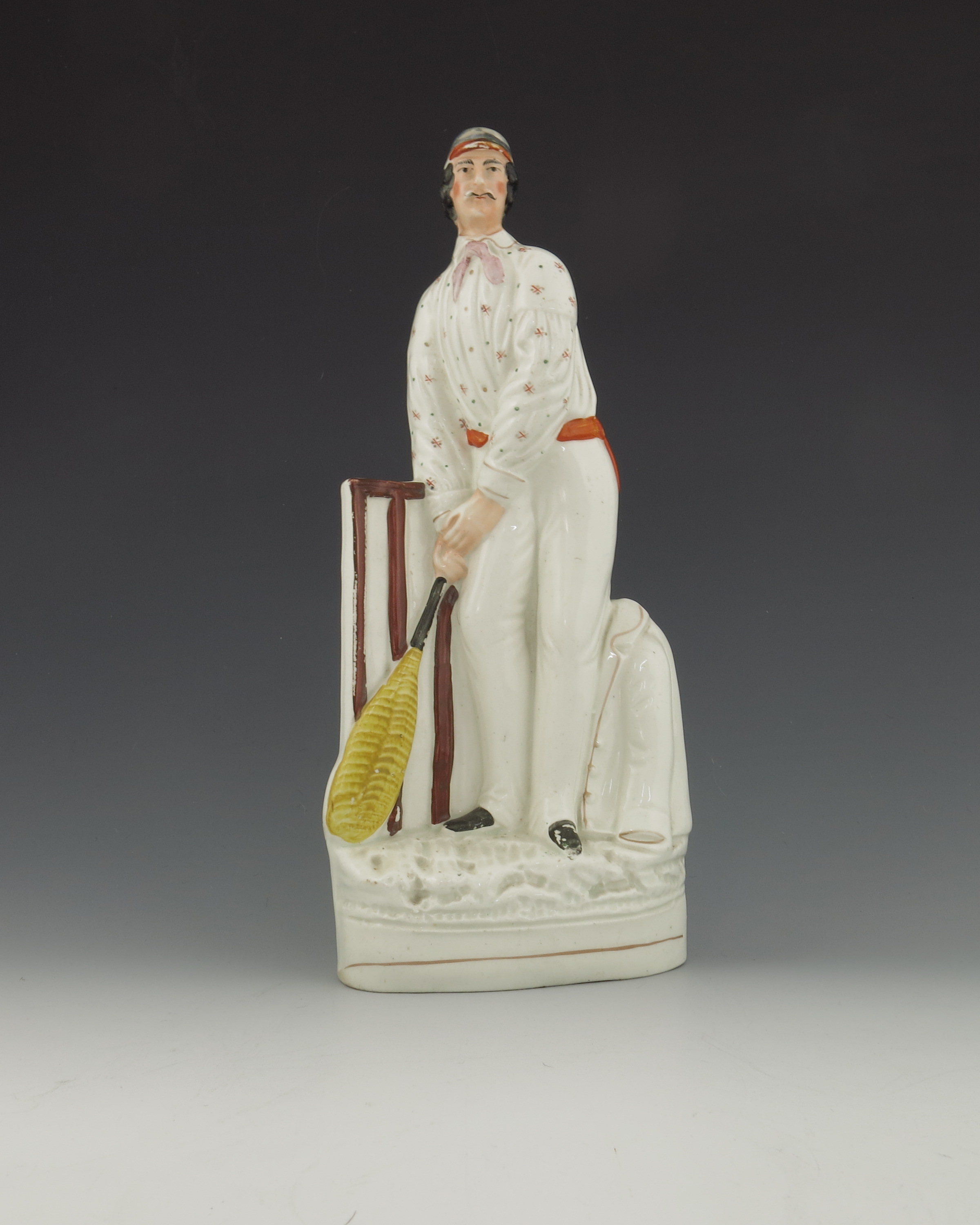A Staffordshire figure of a cricketer, circa 1860, modelled as a batsmen at the wicket, standing bes - Image 2 of 4