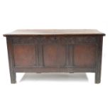 A late 17th Century oak plank chest, circa 1690, moulded edge top, wire hinges, lunette carved
