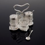 An Edwardian silver and cut glass four piece cruet, Joseph Gloster Ltd., Birmingham 1909 and 1910