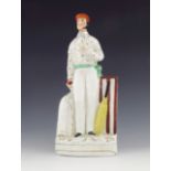 A Staffordshire pottery figure of the cricketer George Parr, circa 1861, modelled standing beside a