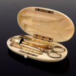 A 19th century French silver gilt and ivory cased sewing set