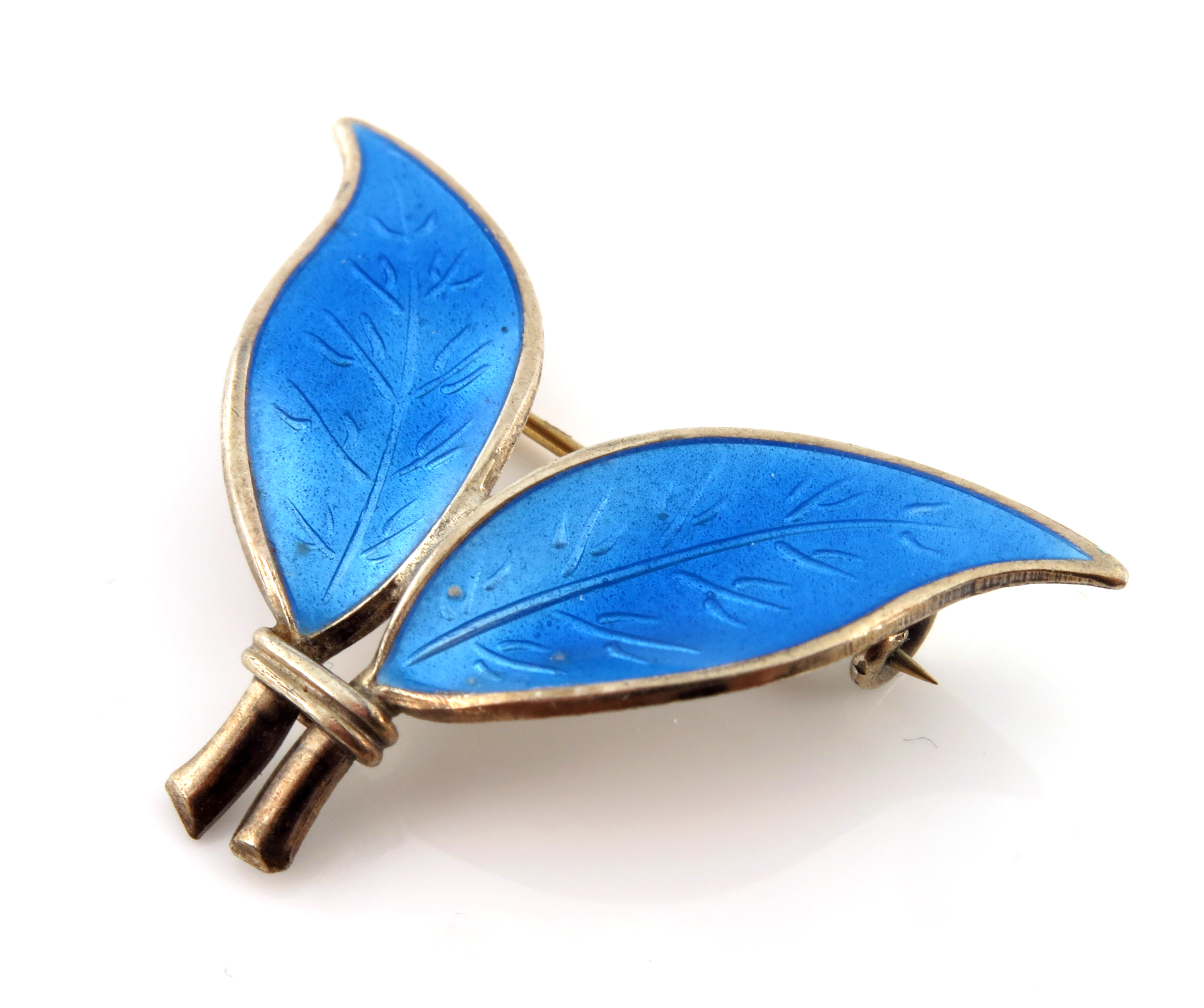 Willy Winnaess for David Andersen, a Norwegian silver gilt and enamelled two leaf brooch