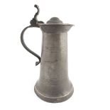 An 18th Century pewter lidded communion flagon, of large size with erect thumbpiece and curve