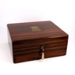 A William IV rosewood dressing case, circa 1833, the cover with inlaid brass monogram surmounted