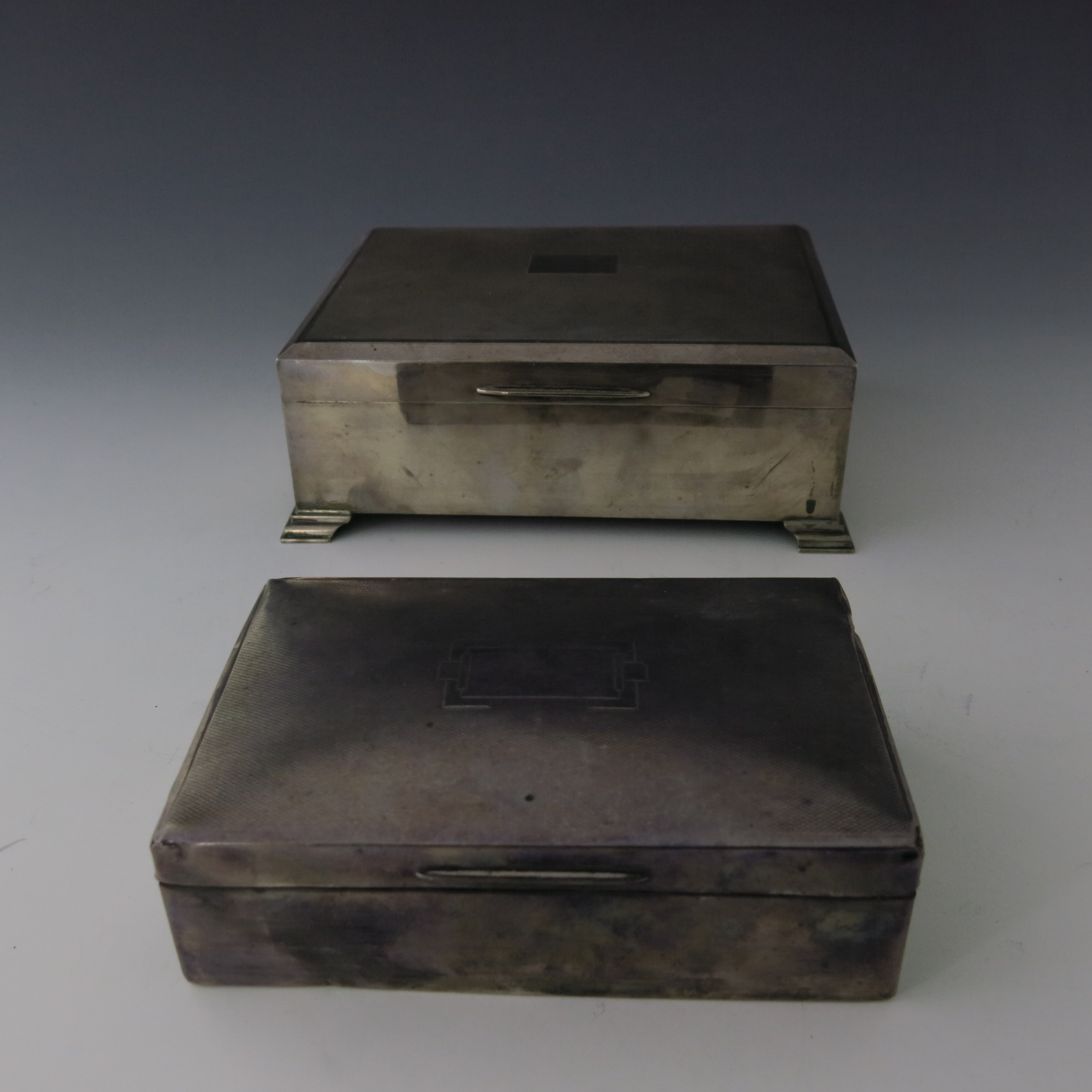 An Elizabeth II silver table cigarette casket, machine engraved cover, stepped bracket feet, maker - Image 2 of 5