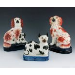 A Staffordshire figure of a spaniel, circa 1860, modelled seated, iron red and white colourway, on a