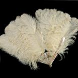 A late 19th/early 20th Century French white ostrich feather fan, mother of pearl guards and sticks