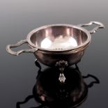 An Elizabeth II silver tea strainer and stand, Barker Ellis Silver Co., Birmingham 1987