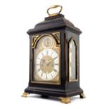 A George III ebonised bracket clock, caddy top with brass swing handle, arched brass dial with
