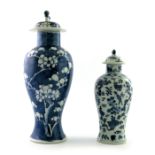 Two Chinese blue and white temple vases and covers, 19th Century, the smaller decorated with birds