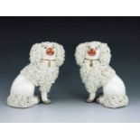A pair of Staffordshire pottery poodles, circa 1860, modelled seated with textured fir and gilt coll