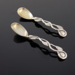 A matched pair of Victorian cast silver vine handled mustard spoons