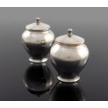 W A S Benson, a pair of Arts and Crafts silver plated tea caddies