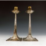 After Jan Eisenloffel, a pair of Arts and Crafts silver candlestick lamp bases, Gibson and Co., 1908