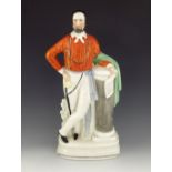 A Staffordshire figure of Garibaldi, circa 1865, modelled standing and leaning on a column, on a pli