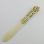 λ An ivory letter knife, 19th Century, probably Dieppe, the handle profusely carved with fruiting