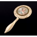 λ An ivory miniature hand mirror, 19th Century, possibly Dieppe, wrythen turned handle, scroll