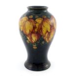 William Moorcroft, a flambe Leaf and Berry vase, inverse baluster form, circa 1927, impressed