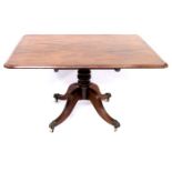 A Regency mahogany breakfast table, circa 1820, rectangular moulded tilt-top, baluster pedestal,