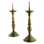 A pair of brass pricket candlesticks, Flemish, 17th Century, the prickets over dished drip pans,