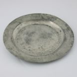 An 18th Century pewter single reeded charger with ownership initials, engraved to the reverse, circa