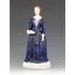 A Staffordshire figure of Florence Nightingale, titled 'Miss F Nightingale', circa 1855, modelled st