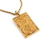 A 14k yellow gold rectangular reticulated pendant