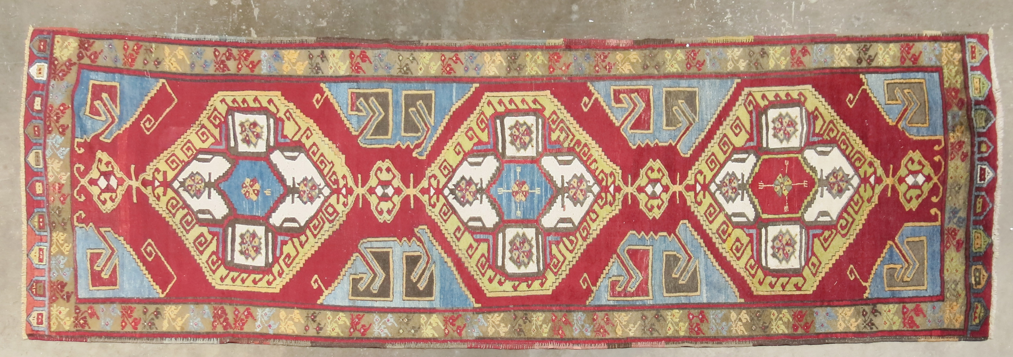 A Turkish Karapinar long rug, of traditional village design, 370 by 121cm