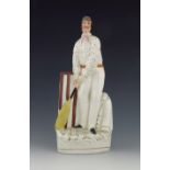 A Staffordshire figure of a cricketer, circa 1860, modelled as a batsmen at the wicket, standing bes