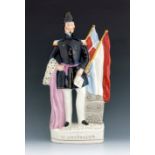 A Staffordshire Crimean War figure of General Pelissier, circa 1855, modelled standing beside flags,