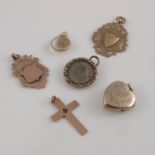 A collection of 9ct yellow gold and gold metal pendants