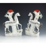 A pair of Staffordshire flat back spill vases, circa 1870, modelled as zebras standing before a tree