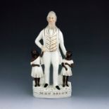A Staffordshire figure of the Abolitionist John Brown, circa 1863, modelled standing in white dress