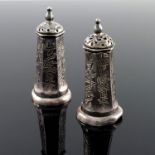 A pair of Chinese white metal salt and pepper pots