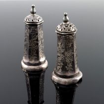 A pair of Chinese white metal salt and pepper pots