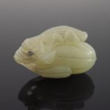 A Chinese pale jade netsuke, in the form of a gourd surmounted by a locust, 5cm wide