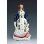 A Staffordshire figure of 'Eliza Cook', circa 1850, modelled standing on a titled oval base, wearing