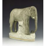 A Staffordshire figure of Jumbo the elephant, titled 'Jumbo', circa 1875, on an oval plinth base, 28