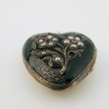 A late 19th century gold metal and enamelled heart shaped locket