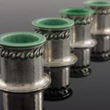 A set of four Arts and Crafts silver and ceramic salt cellars, circa 1900