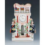 A Staffordshire pottery clock figure, circa 1850, possibly modelled as Euston Station, with two figu