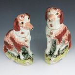 A pair of Staffordshire pottery dogs, circa 1860, modelled as setters, in rust and white colourway w