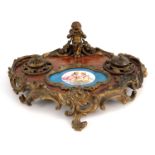A 19th Century French double desk inkstand, of Rococo design, gilt metal scrollwork frame surmounted